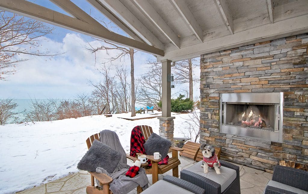 Lake views abound from the cozy covered patio with plenty of seating and fireplace to take the chill out of the air.