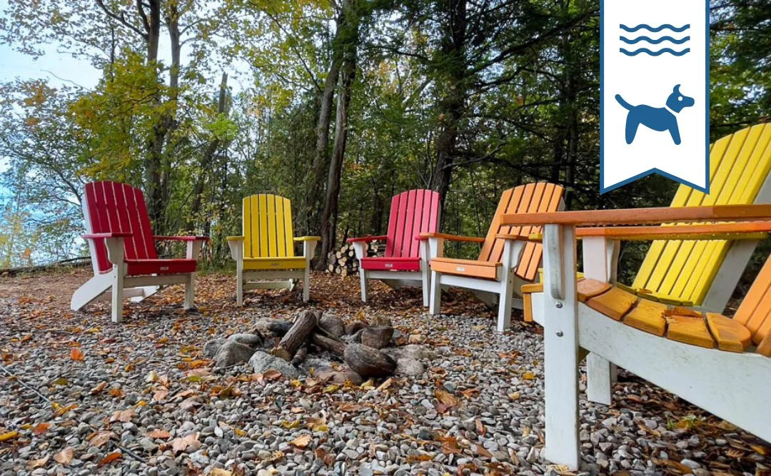 Colorful Adirondack chairs around fire pit for couples getaway lakeside gathering in Grand Bend