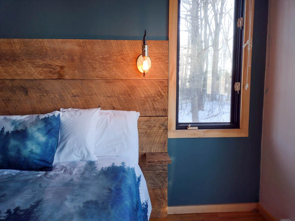 Modern bedroom with forest view at a Lake Huron cottage for a couples getaway Grand Bend